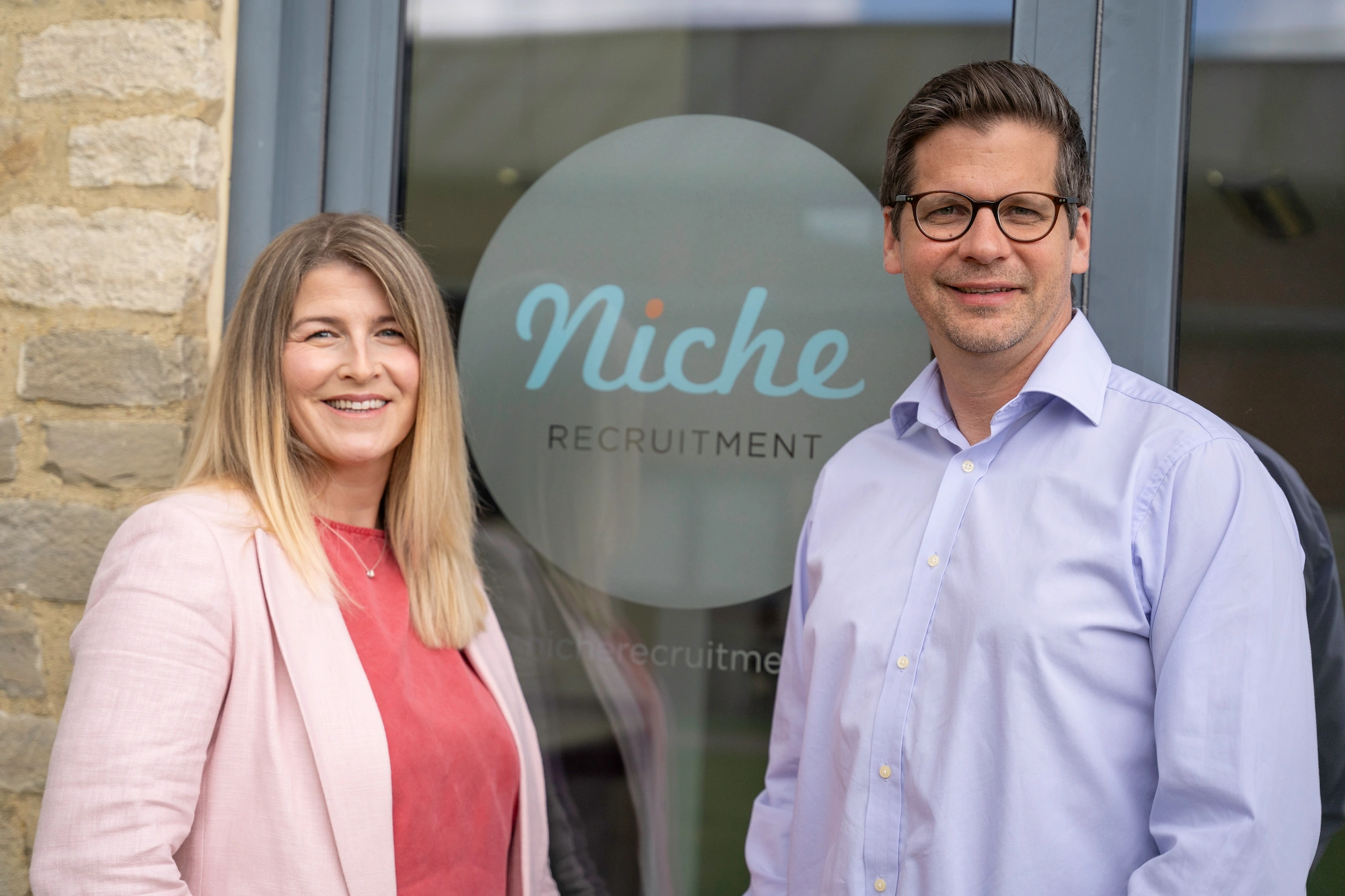 Photo of founders Nick and Michelle outside the Niche offices.